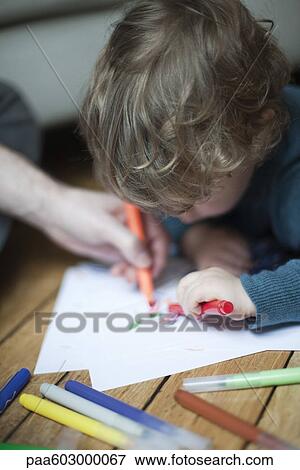 Toddler boy and parent drawing together on paper View Large Photo Image Stock Photo - Toddler boy and parent drawing together on paper. Fotosearch