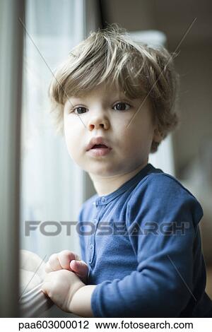 Toddler boy by window, portrait View Large Photo Image Stock Image - Toddler boy by window, portrait. Fotosearch