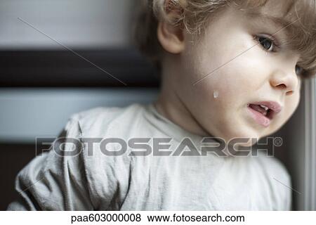 Stock Photo - Toddler boy crying, portrait. Fotosearch