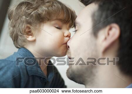 Toddler boy kissing father's nose View Large Photo Image Picture - Toddler boy kissing father's nose. Fotosearch