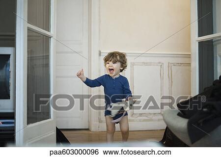 Stock Photograph - Toddler boy playing and laughing. Fotosearch