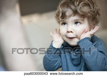 Toddler boy playing and making face, portrait View Large Photo Image Stock Image - Toddler boy playing and making face, portrait. Fotosearch