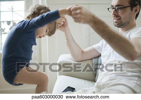 Stock Image - Toddler boy playing with father. Fotosearch