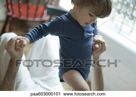 Stock Image - Toddler boy playing with father. Fotosearch