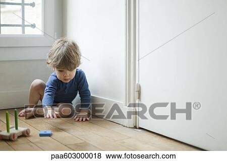 Stock Photo - Toddler boy playing with toy. Fotosearch