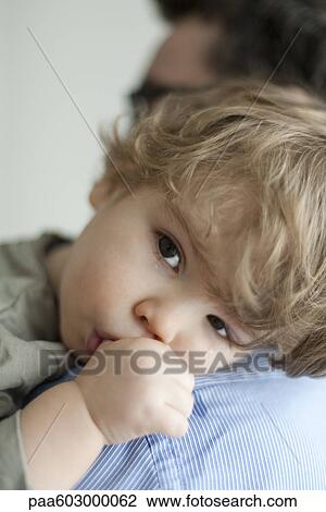Toddler boy resting head on father's shoulder, tears on face View Large Photo Image Stock Image - Toddler boy resting head on father's shoulder, tears on face. Fotosearch