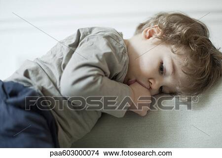 Toddler boy sucking thumb, portrait View Large Photo Image Picture - Toddler boy sucking thumb, portrait. Fotosearch