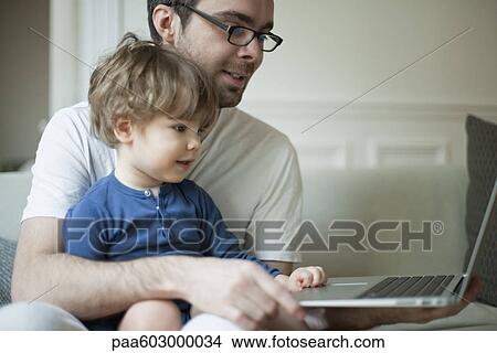 Toddler boy using laptop computer with father View Large Photo Image Picture - Toddler boy using laptop computer with father. Fotosearch