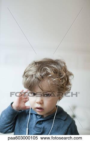 Toddler boy wearing earphones, portrait View Large Photo Image Stock Photography - Toddler boy wearing earphones, portrait. Fotosearch