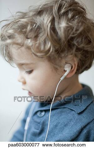 Toddler boy wearing earphones, profile View Large Photo Image Stock Photo - Toddler boy wearing earphones, profile. Fotosearch