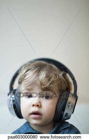 Toddler boy wearing headphones, portrait View Large Photo Image Stock Image - Toddler boy wearing headphones, portrait. Fotosearch