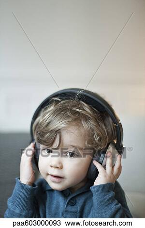Toddler boy wearing headphones, portrait View Large Photo Image Stock Image - Toddler boy wearing headphones, portrait. Fotosearch