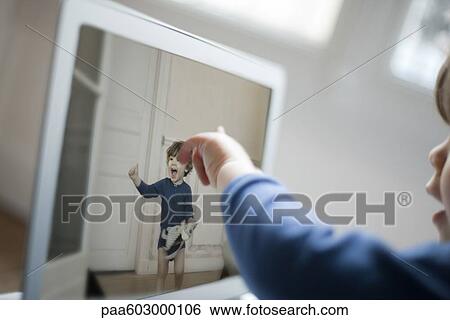 Toddler pointing at laptop screen View Large Photo Image Stock Photograph - Toddler pointing at laptop screen. Fotosearch