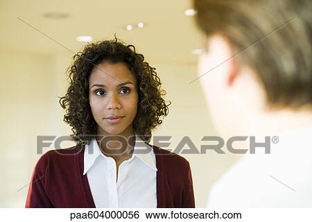 Businesswoman listening to colleague View Large Photo Image Stock Photograph - Businesswoman listening to colleague. Fotosearch