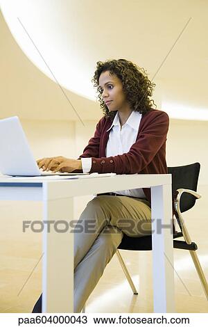 Businesswoman typing on laptop View Large Photo Image Stock Image - Businesswoman typing on laptop. Fotosearch