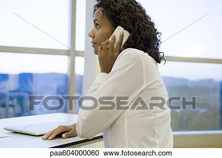 Businesswoman using cell phone View Large Photo Image Stock Image - Businesswoman using cell phone. Fotosearch