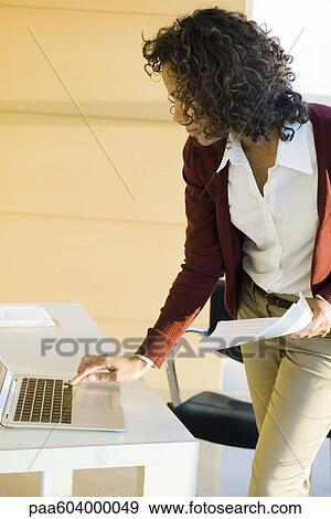 Businesswoman using laptop computer View Large Photo Image Stock Photo - Businesswoman using laptop computer. Fotosearch