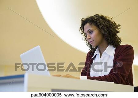 Stock Photography - Businesswoman working on laptop computer. Fotosearch