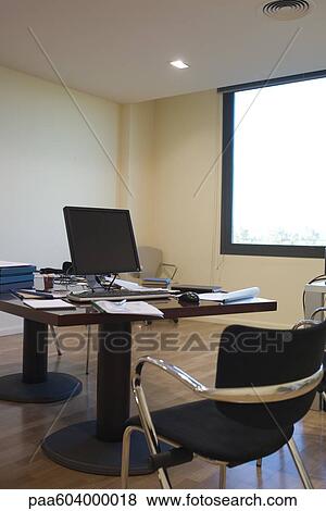 Stock Photo - Computer on messy desk in office. Fotosearch