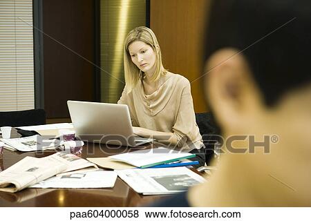 Female executive working on laptop computer View Large Photo Image Stock Photo - Female executive working on laptop computer. Fotosearch
