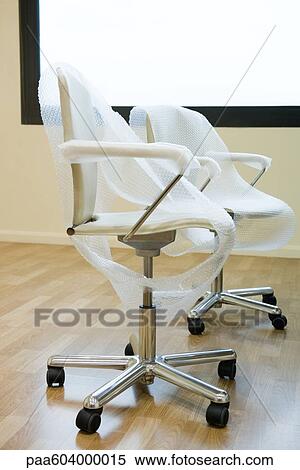 New office chairs covered in bubble wrap View Large Photo Image Stock Photography - New office chairs covered in bubble wrap. Fotosearch