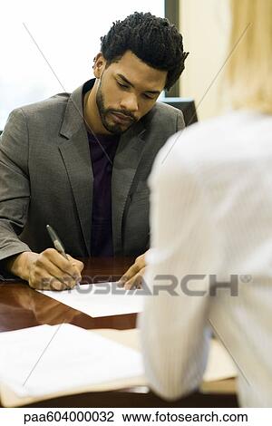 Professional man completing application at job interview View Large Photo Image Stock Image - Professional man completing application at job interview. Fotosearch
