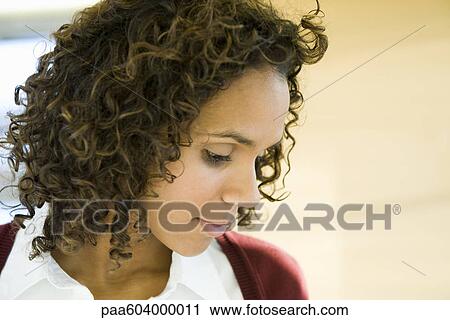 Woman looking down in thought, portrait View Large Photo Image Stock Image - Woman looking down in thought, portrait. Fotosearch