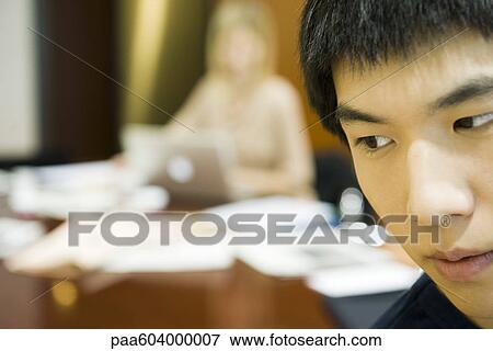 Young man looking away in thought View Large Photo Image Stock Photo - Young man looking away in thought. Fotosearch
