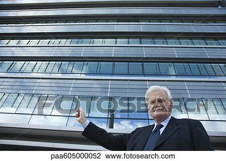 Executive gesturing at office building View Large Photo Image Stock Image - Executive gesturing at office building. Fotosearch