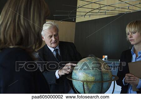 Executive outlining future global business plans to colleagues View Large Photo Image Stock Image - Executive outlining future global business plans to colleagues. Fotosearch