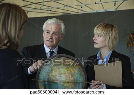 Executive outlining future plans of global business to colleagues View Large Photo Image Stock Image - Executive outlining future plans of global business to colleagues. Fotosearch