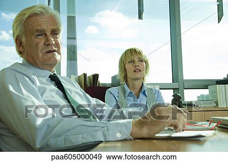 Stock Photo - Executives brainstorming in meeting. Fotosearch