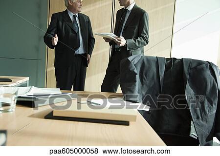 Executives discussing work View Large Photo Image Stock Photo - Executives discussing work. Fotosearch
