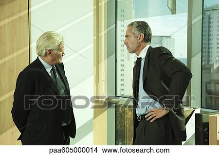 Executives having private conversation View Large Photo Image Picture - Executives having private conversation. Fotosearch