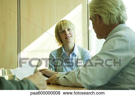 Supervisor evaluating young associate's job performance View Large Photo Image Stock Photo - Supervisor evaluating young associate's job performance. Fotosearch