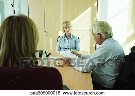 Supervisors evaluating young associate's job performance View Large Photo Image Stock Photo - Supervisors evaluating young associate's job performance. Fotosearch