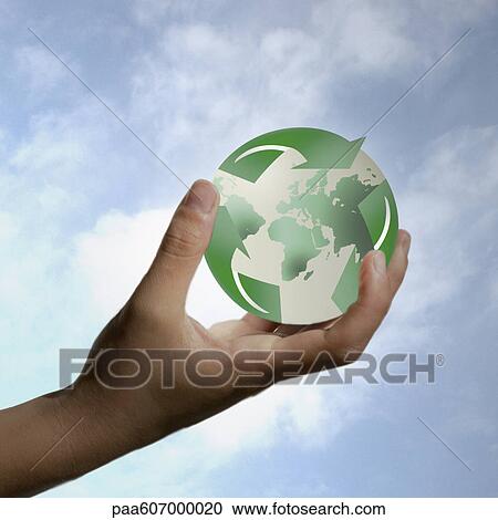 Hand holding planet earth enveloped by recycling symbol View Large Photo Image Stock Image - Hand holding planet earth enveloped by recycling symbol. Fotosearch