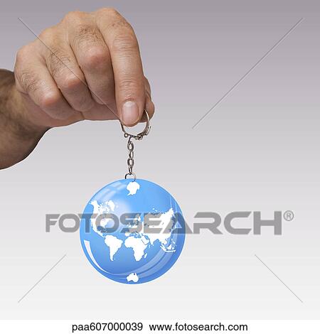 Hand holding planet earth key ring View Large Photo Image Stock Photo - Hand holding planet earth key ring. Fotosearch