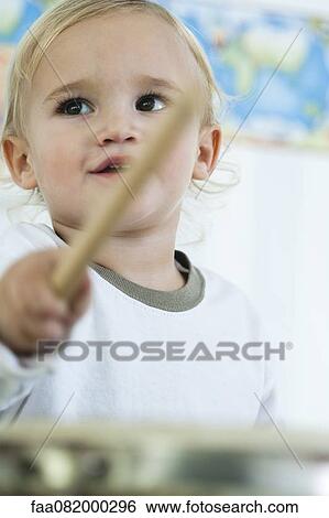 Baby boy playing drum, low angle view View Large Photo Image Stock Photograph - Baby boy playing drum, low angle view. Fotosearch