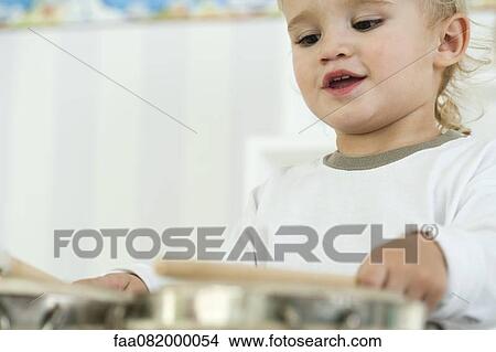 Baby boy playing drums, low angle view View Large Photo Image Picture - Baby boy playing drums, low angle view. Fotosearch