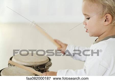 Baby boy playing drums, side view View Large Photo Image Stock Photo - Baby boy playing drums, side view. Fotosearch