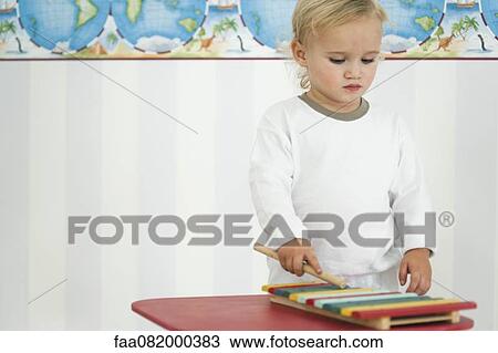 Baby boy playing toy xylophone View Large Photo Image Stock Image - Baby boy playing toy xylophone. Fotosearch
