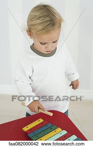 Baby boy playing with toy xylophone View Large Photo Image Stock Image - Baby boy playing with toy xylophone. Fotosearch