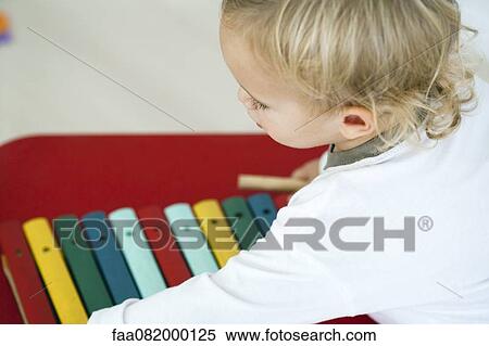 Stock Photography - Baby boy with toy xylophone, high angle view. Fotosearch
