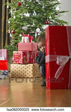 Baby girl hiding behind Christmas present View Large Photo Image Stock Photography - Baby girl hiding behind Christmas present. Fotosearch