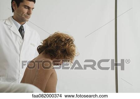 Boy in doctor's office View Large Photo Image Picture - Boy in doctor's office. Fotosearch