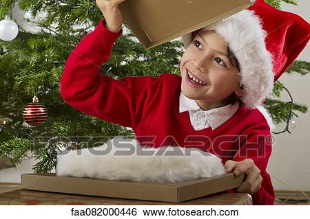Boy opening Christmas present View Large Photo Image Stock Photograph - Boy opening Christmas present. Fotosearch