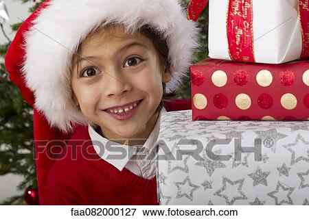 Boy with stack of Christmas presents, portrait View Large Photo Image Stock Photo - Boy with stack of Christmas presents, portrait. Fotosearch