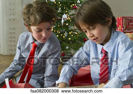 Boys opening Christmas presents View Large Photo Image Stock Photo - Boys opening Christmas presents. Fotosearch