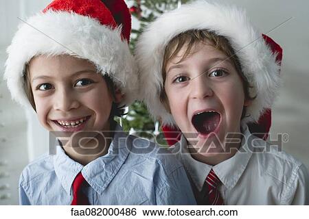 Boys wearing Santa hats, portrait View Large Photo Image Stock Photograph - Boys wearing Santa hats, portrait. Fotosearch